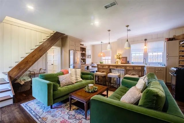 a living room with furniture and a view of kitchen