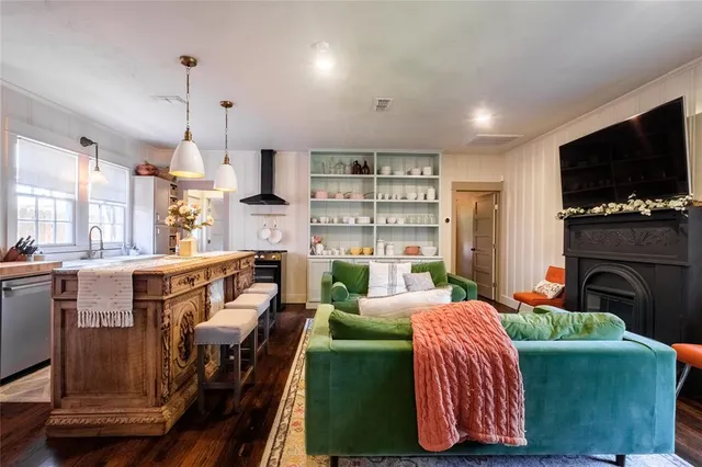 a living room with furniture a flat screen tv and a fireplace