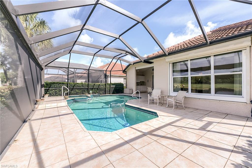 9156 Spring Run Boulevard Estero, FL 34135 - Photo 25 of 34 a view of a swimming pool with a patio