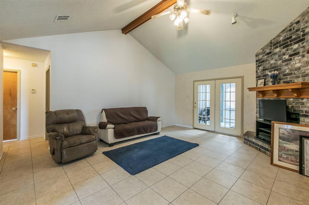 1936 Post Oak Drive Waco, TX 76705 - Photo 4 of 33 Living area featuring a textured ceiling, light tile patterned floors, a ceiling fan, and french doors
