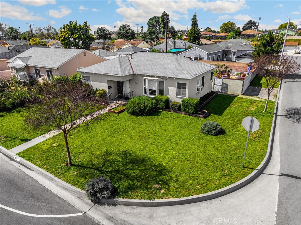 4577 Ranger Avenue El Monte, CA 91731 - Photo 3 of 25 a view of a white house with a big yard and potted plants