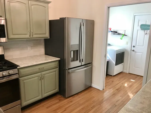 a kitchen with a refrigerator sink and cabinets