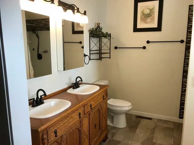 a bathroom with a toilet sink and mirror