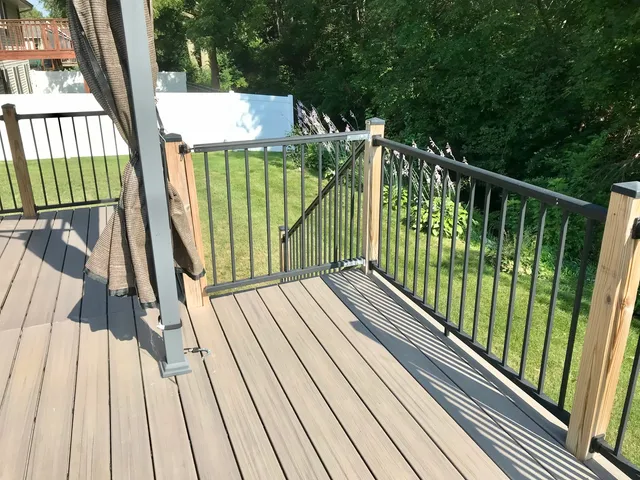 a view of balcony with wooden floor and fence