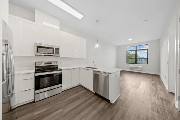 a bathroom with a granite countertop sink a toilet and bathtub