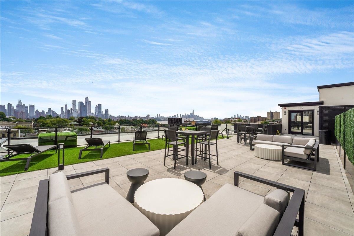 121 34th Street, Unit 415 Union City, NJ 07087 - Photo 14 of 41 a view of a terrace with furniture and a garden
