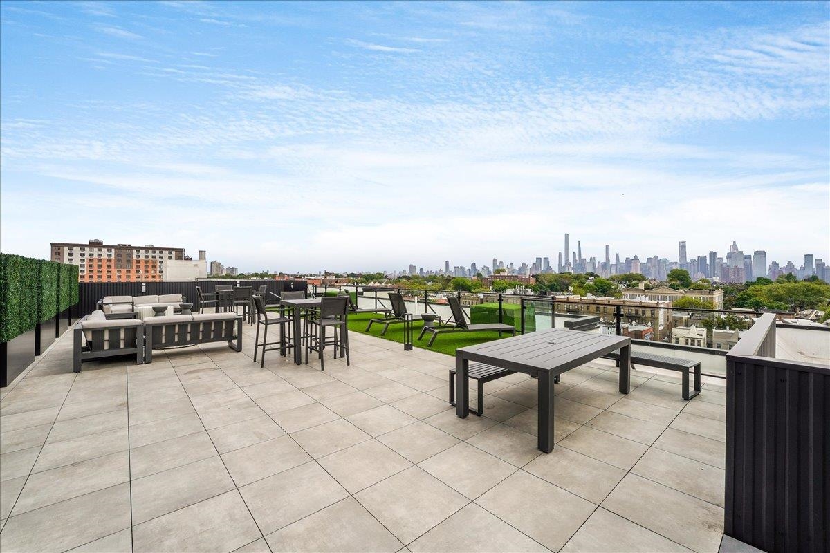 121 34th Street, Unit 415 Union City, NJ 07087 - Photo 17 of 41 a view of a terrace with chairs