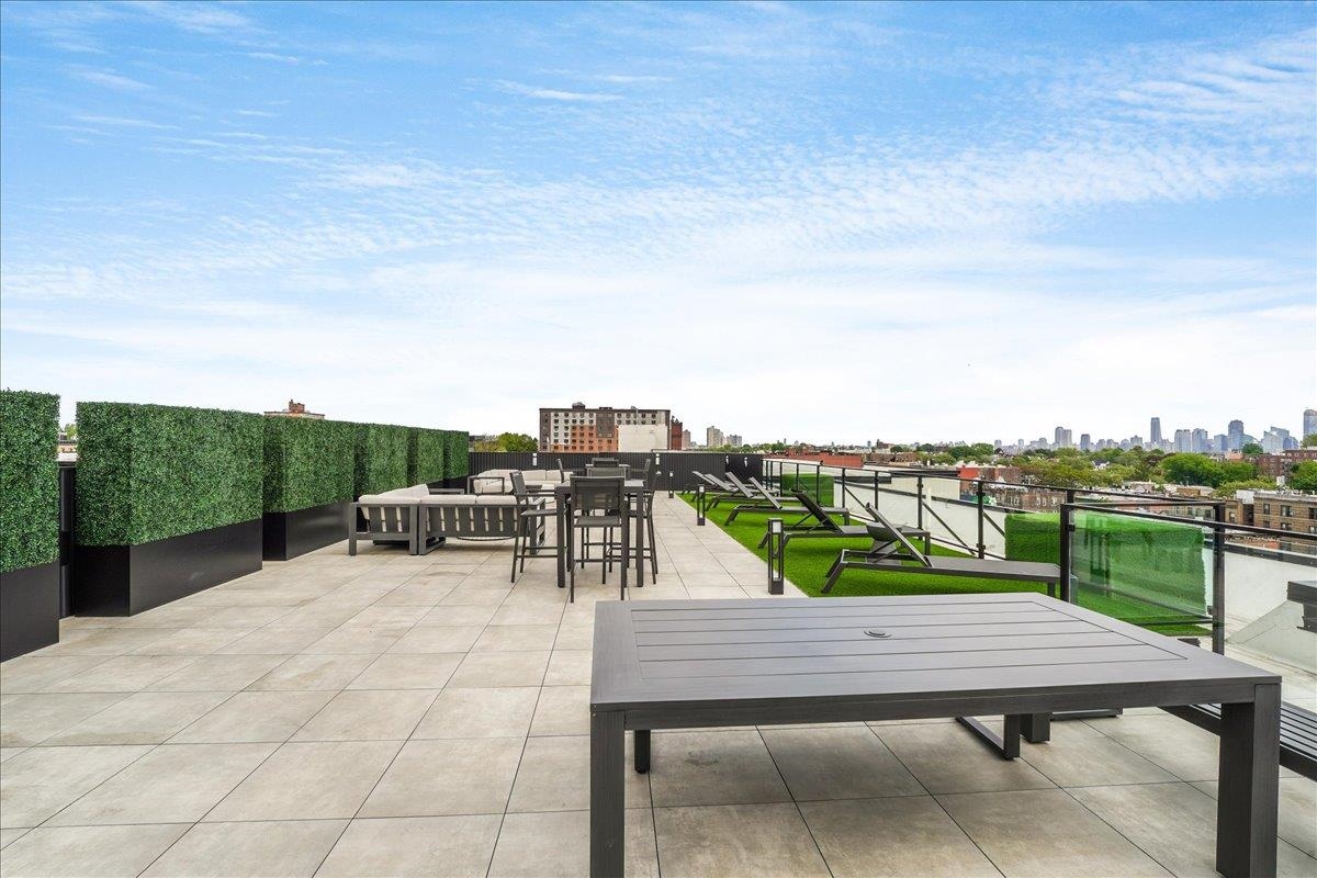 121 34th Street, Unit 415 Union City, NJ 07087 - Photo 26 of 41 a view of a terrace with couches and city view