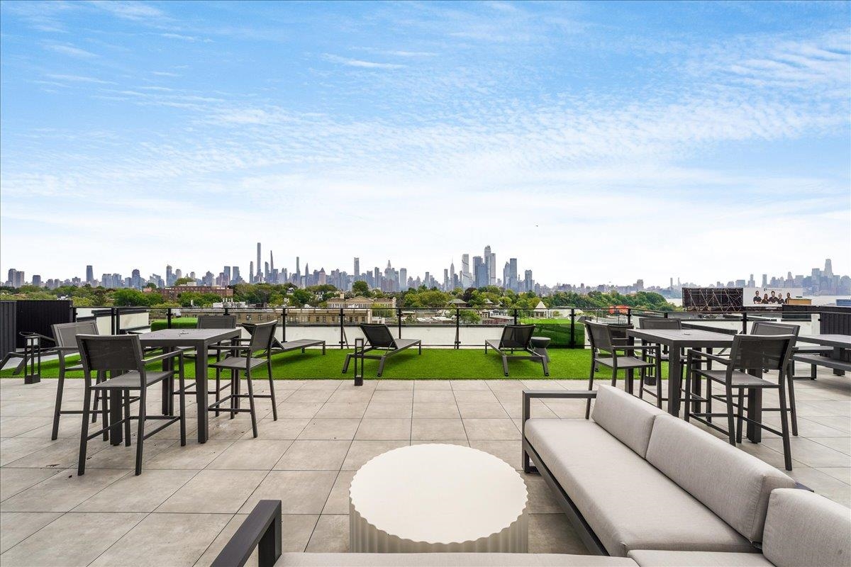 121 34th Street, Unit 415 Union City, NJ 07087 - Photo 27 of 41 a view of a terrace with couches and city view