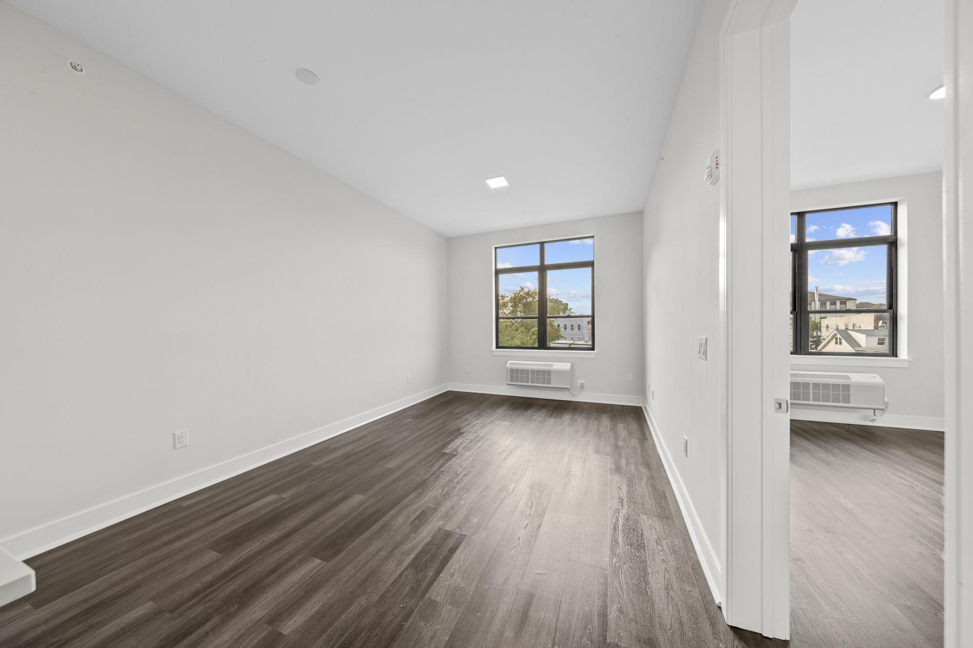 121 34th Street, Unit 415 Union City, NJ 07087 - Photo 5 of 41 wooden floor in an empty room with a window
