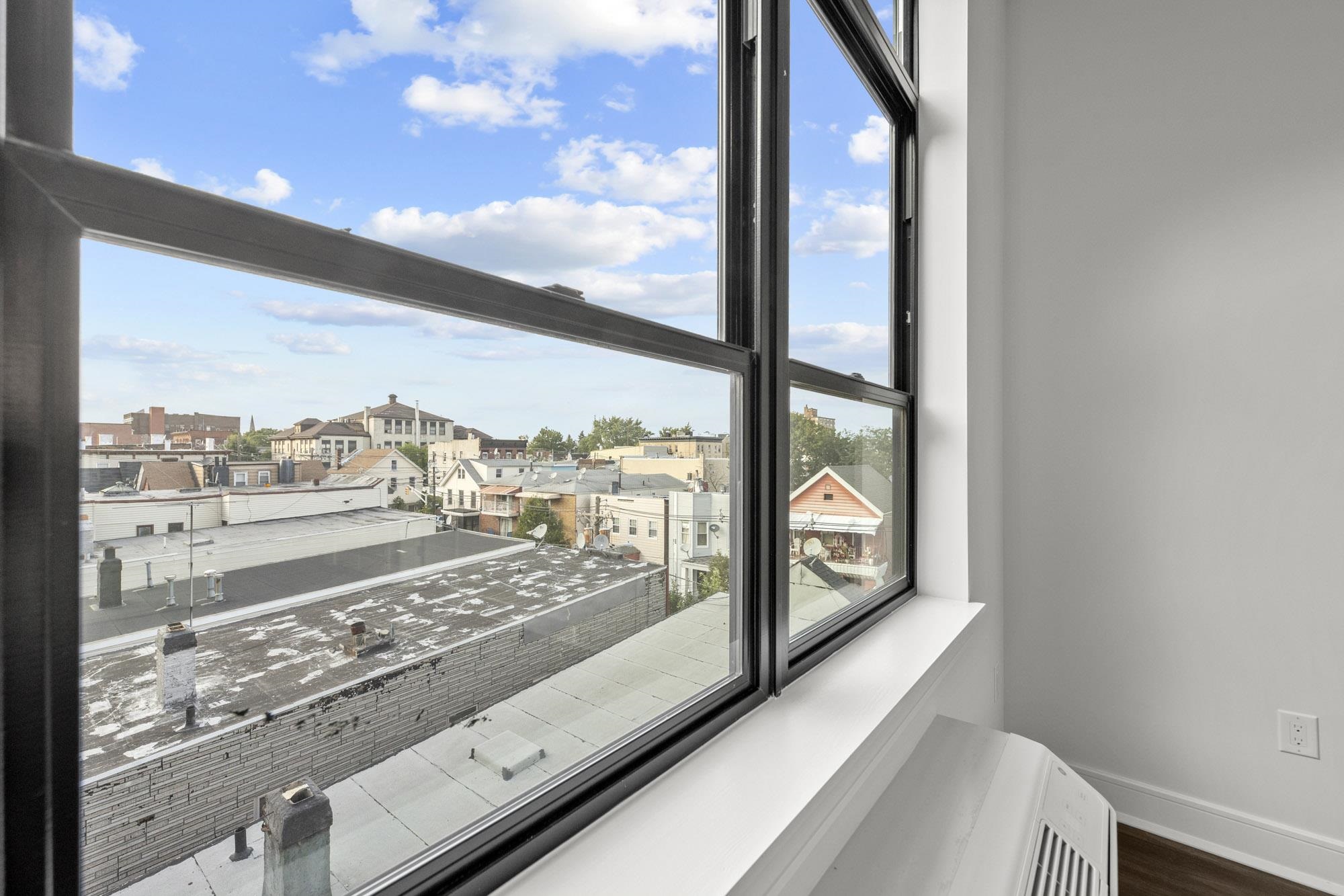 121 34th Street, Unit 415 Union City, NJ 07087 - Photo 6 of 41 a view of a balcony from a window
