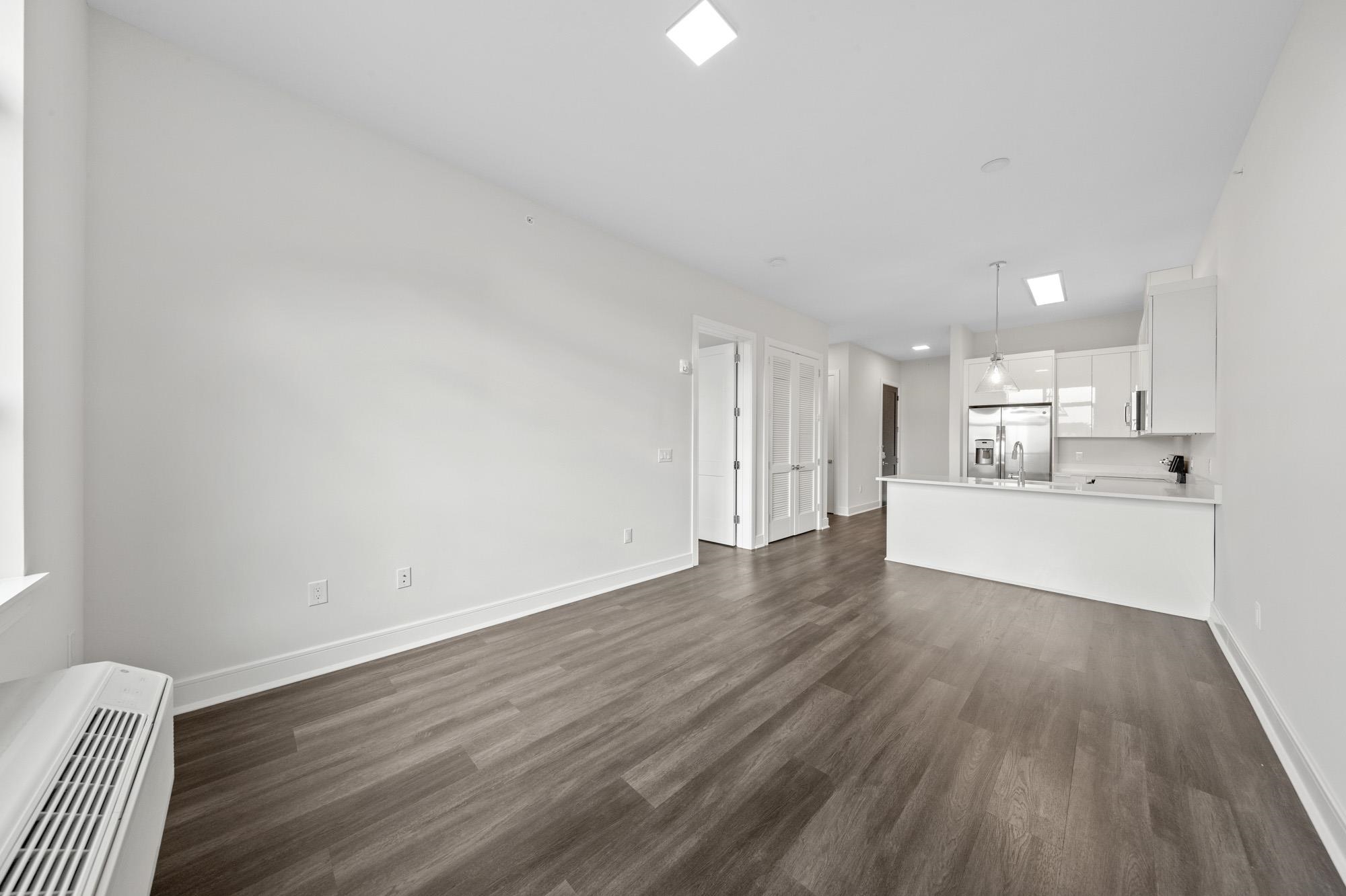 121 34th Street, Unit 415 Union City, NJ 07087 - Photo 7 of 41 a view of a kitchen with wooden floor