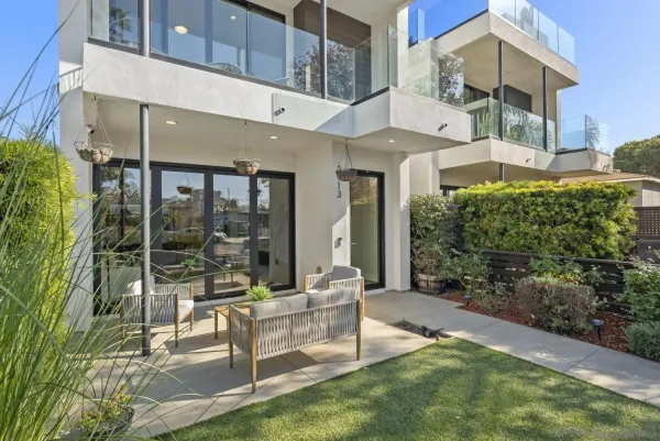 a view of a patio with couches table and chairs and potted plants