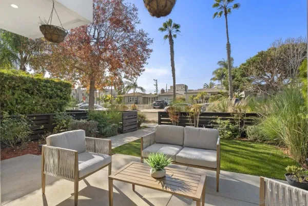 a living room with furniture flat screen tv and a large window