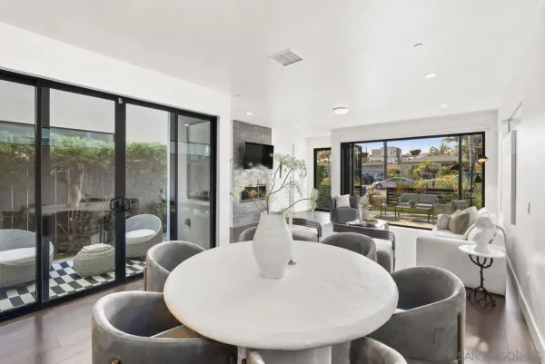 a large white kitchen with a large window a sink and stainless steel appliances