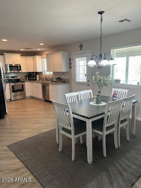 24638 East Bartlett Road Florence, AZ 85132 - Photo 18 of 21 a dining room with furniture a chandelier and kitchen view