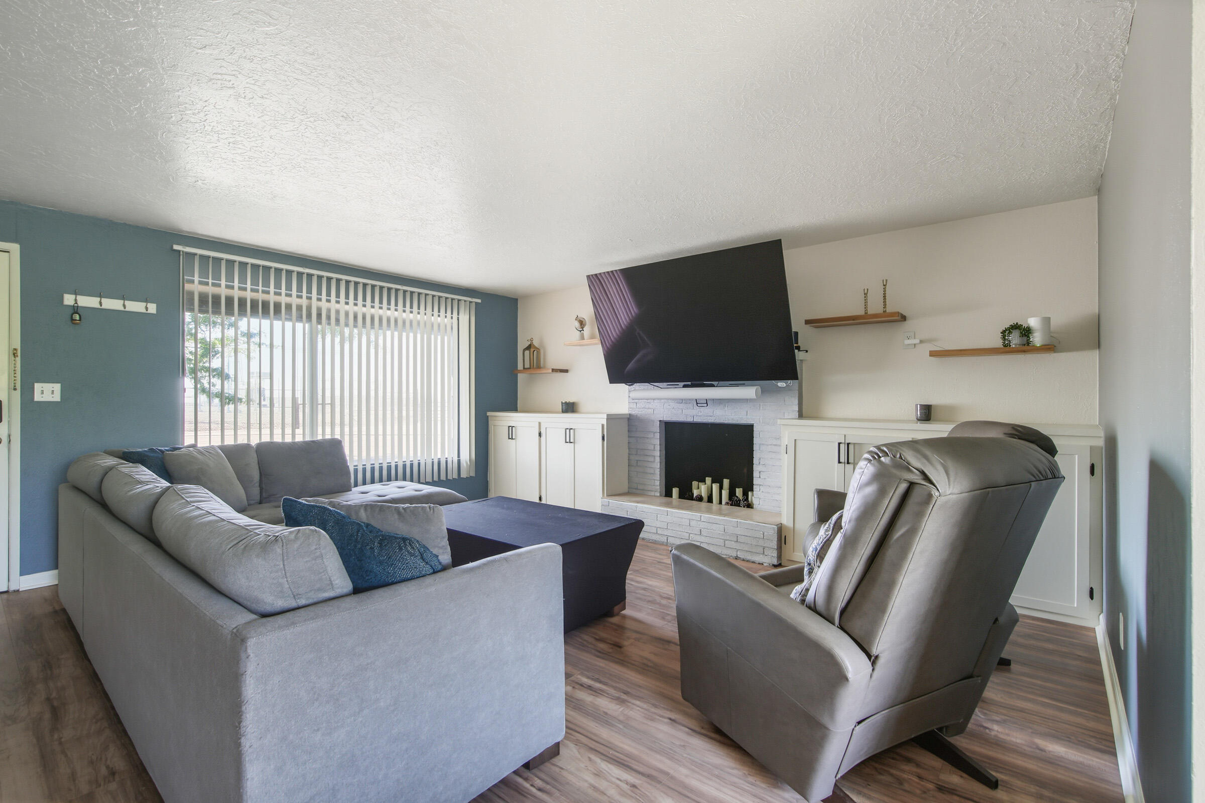 664 Southwest 35th Street Redmond, OR 97756 - Photo 4 of 19 a living room with furniture a fireplace and a flat screen tv