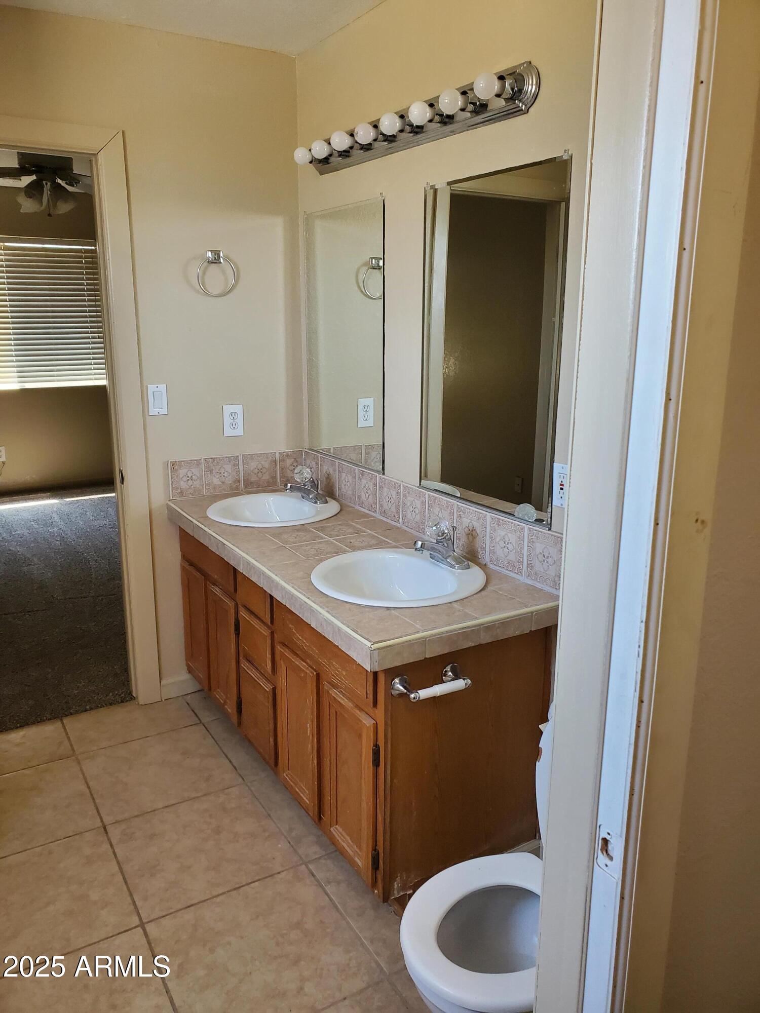 240 East Oak Street Huachuca City, AZ 85616 - Photo 11 of 43 a bathroom with a sink and a mirror