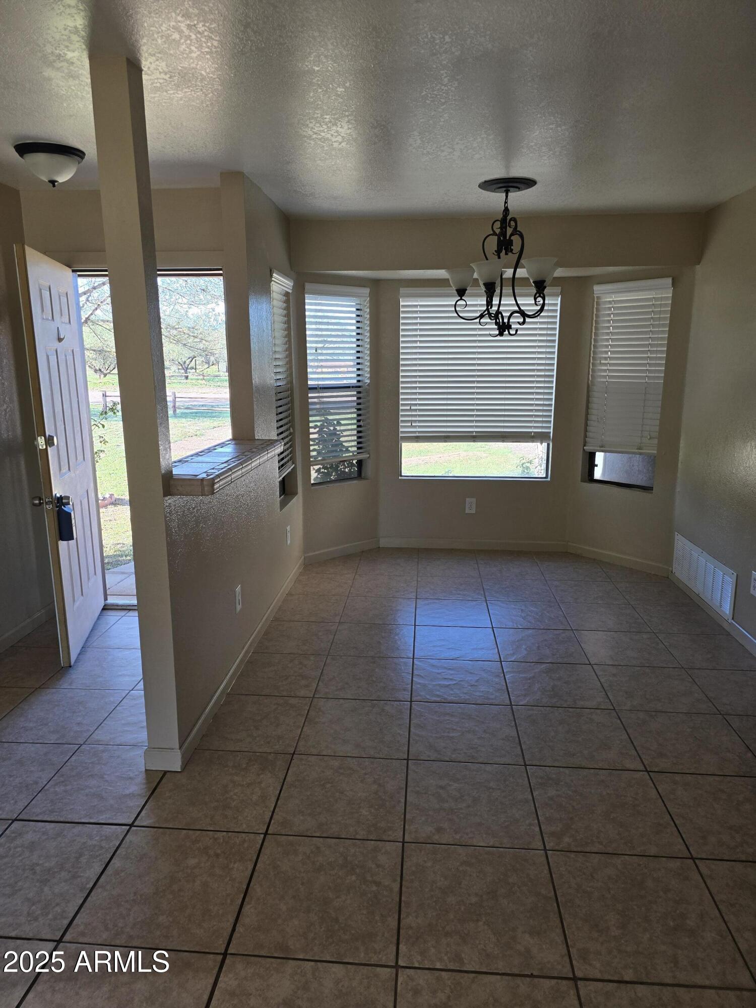 240 East Oak Street Huachuca City, AZ 85616 - Photo 20 of 43 a view of a livingroom with furniture an entryway and a window