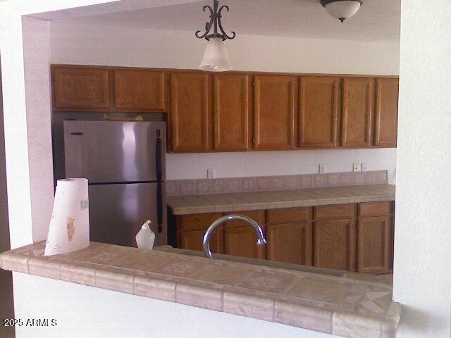 240 East Oak Street Huachuca City, AZ 85616 - Photo 27 of 43 a kitchen with a refrigerator and a sink