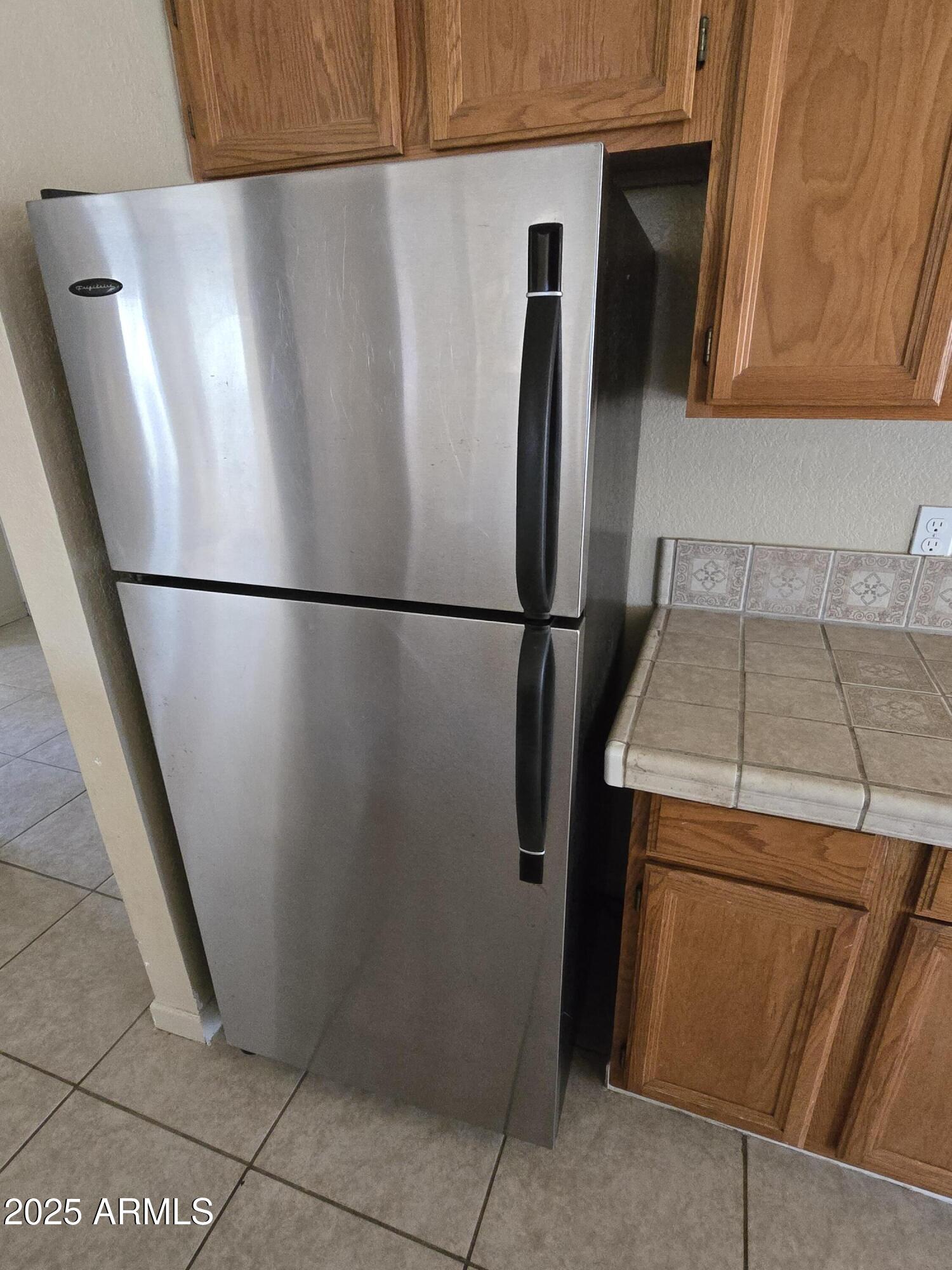240 East Oak Street Huachuca City, AZ 85616 - Photo 29 of 43 a white refrigerator freezer and a stove sitting inside of a kitchen