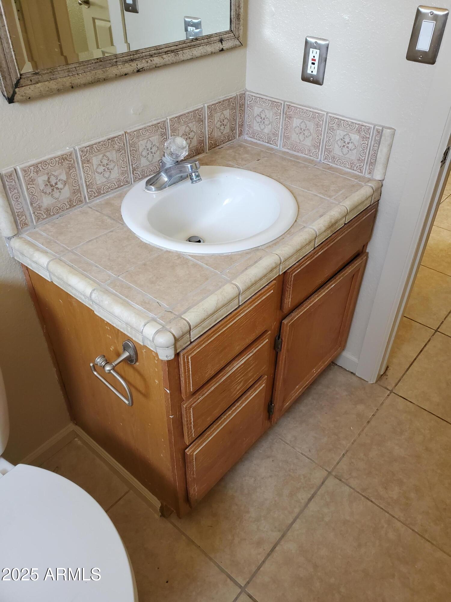 240 East Oak Street Huachuca City, AZ 85616 - Photo 34 of 43 a bathroom with a sink and mirror