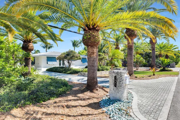 a front view of a house with a yard and sitting area