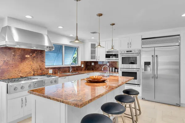 a kitchen with a sink and a stove