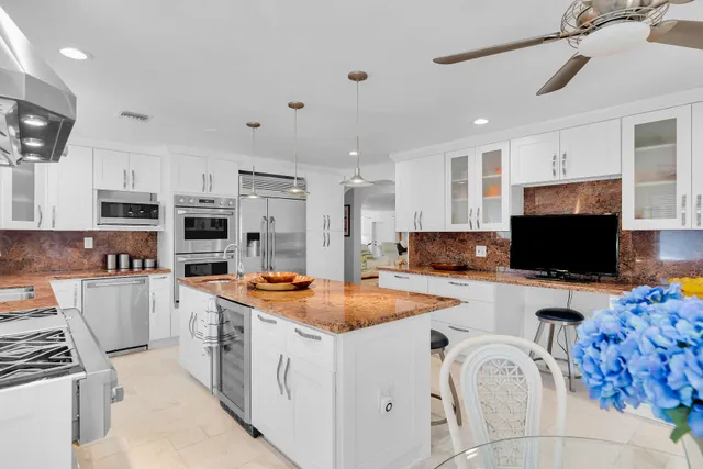 a kitchen with a dining table and chairs