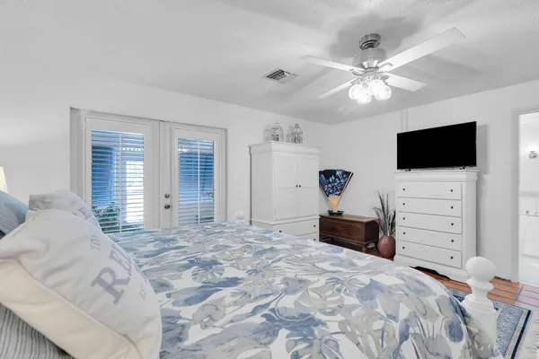 a bedroom with a large bed and a flat screen tv