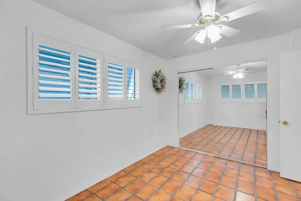 a view of a room that has a window and a plant in it
