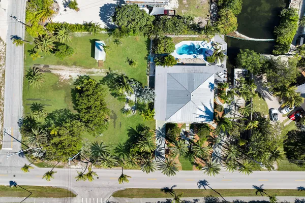 an aerial view of a houses with yard