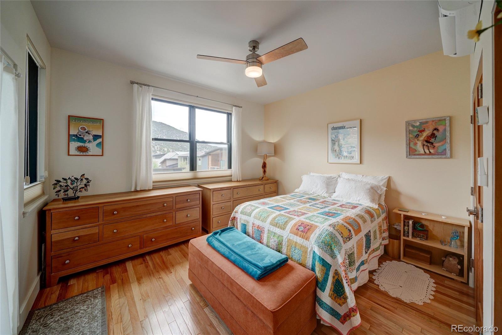 108 Old Stage Road, Unit C Salida, CO 81201 - Photo 12 of 30 a bedroom with a bed and a dresser next to a window
