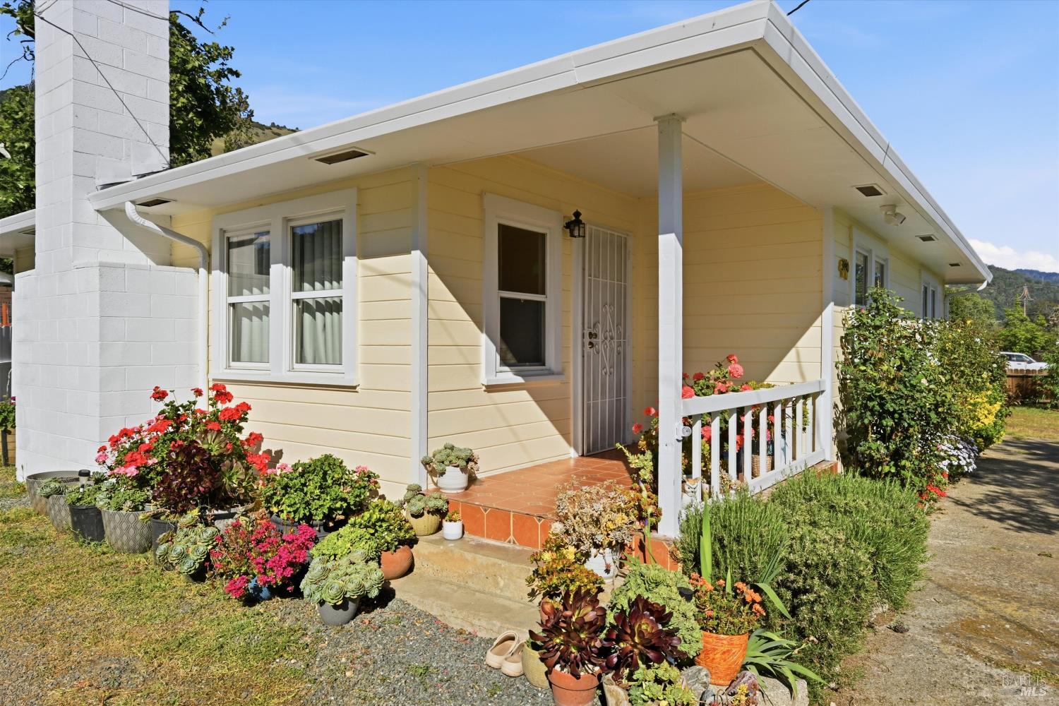 a flower garden is sitting in front of a house