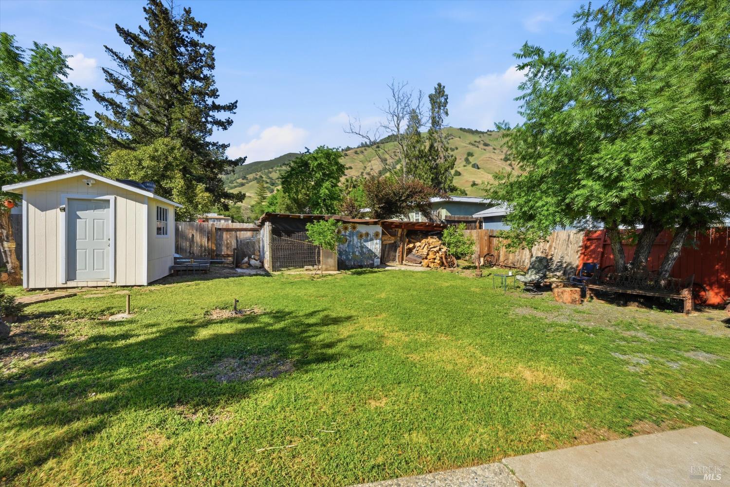 3440 Beach Street Nice, CA 95464 - Photo 26 of 27 a view of a house with backyard and a tree