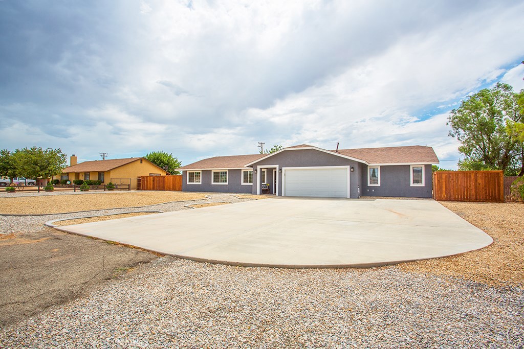 12582 Running Deer Road Apple Valley, CA 92308 - Photo 1 of 1 a front view of a house with a yard and garage