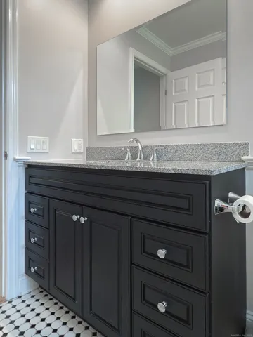 a bathroom with a sink vanity and mirror
