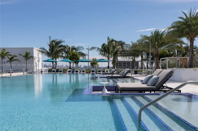 a view of a swimming pool with lounge chairs