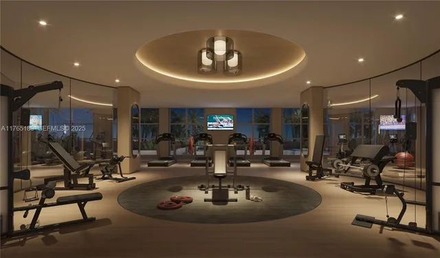 a room with lots of gym equipment and a chandelier