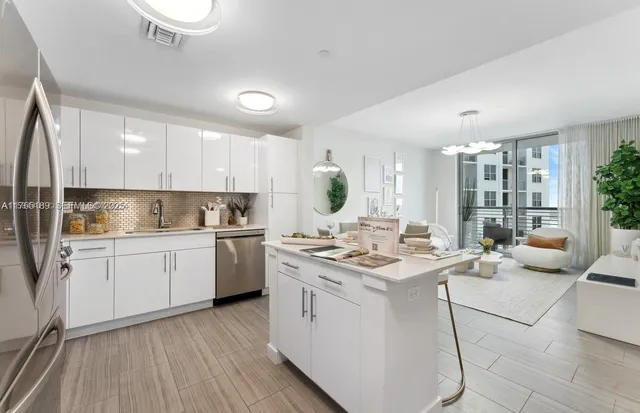 a kitchen with a stove a sink and cabinets