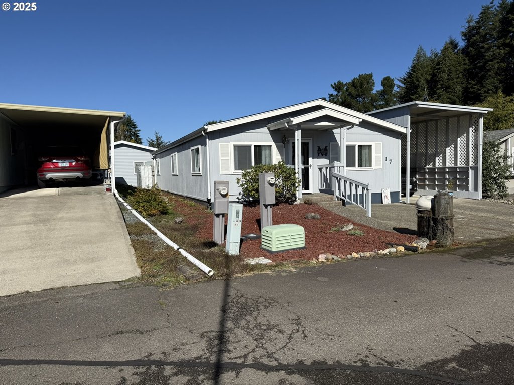 100 River Bend Road, Unit 17 Reedsport, OR 97467 - Photo 1 of 29 a front view of a house with yard