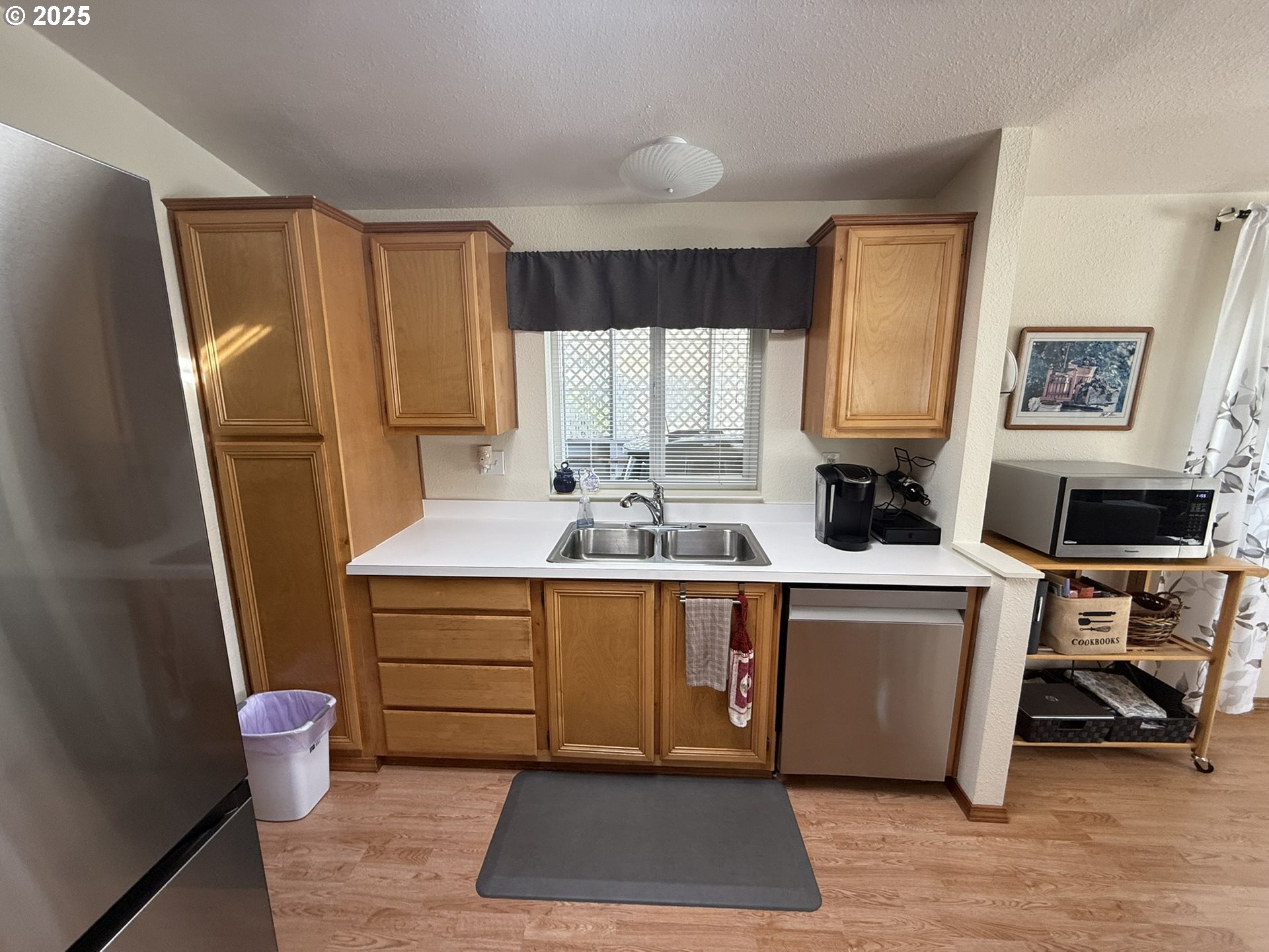 100 River Bend Road, Unit 17 Reedsport, OR 97467 - Photo 11 of 29 a kitchen with a refrigerator sink and cabinets