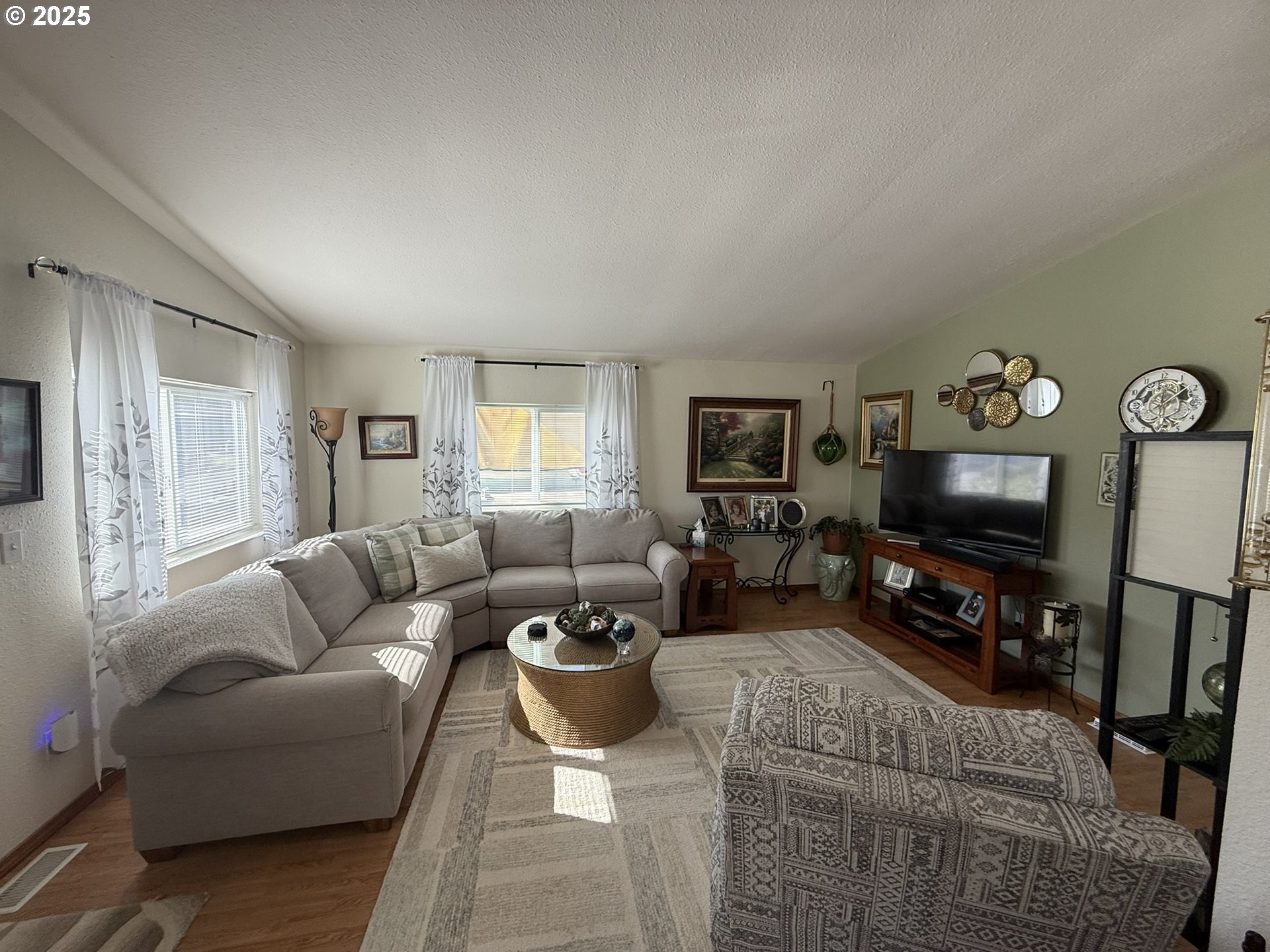 100 River Bend Road, Unit 17 Reedsport, OR 97467 - Photo 6 of 29 a living room with furniture a flat screen tv and a large window