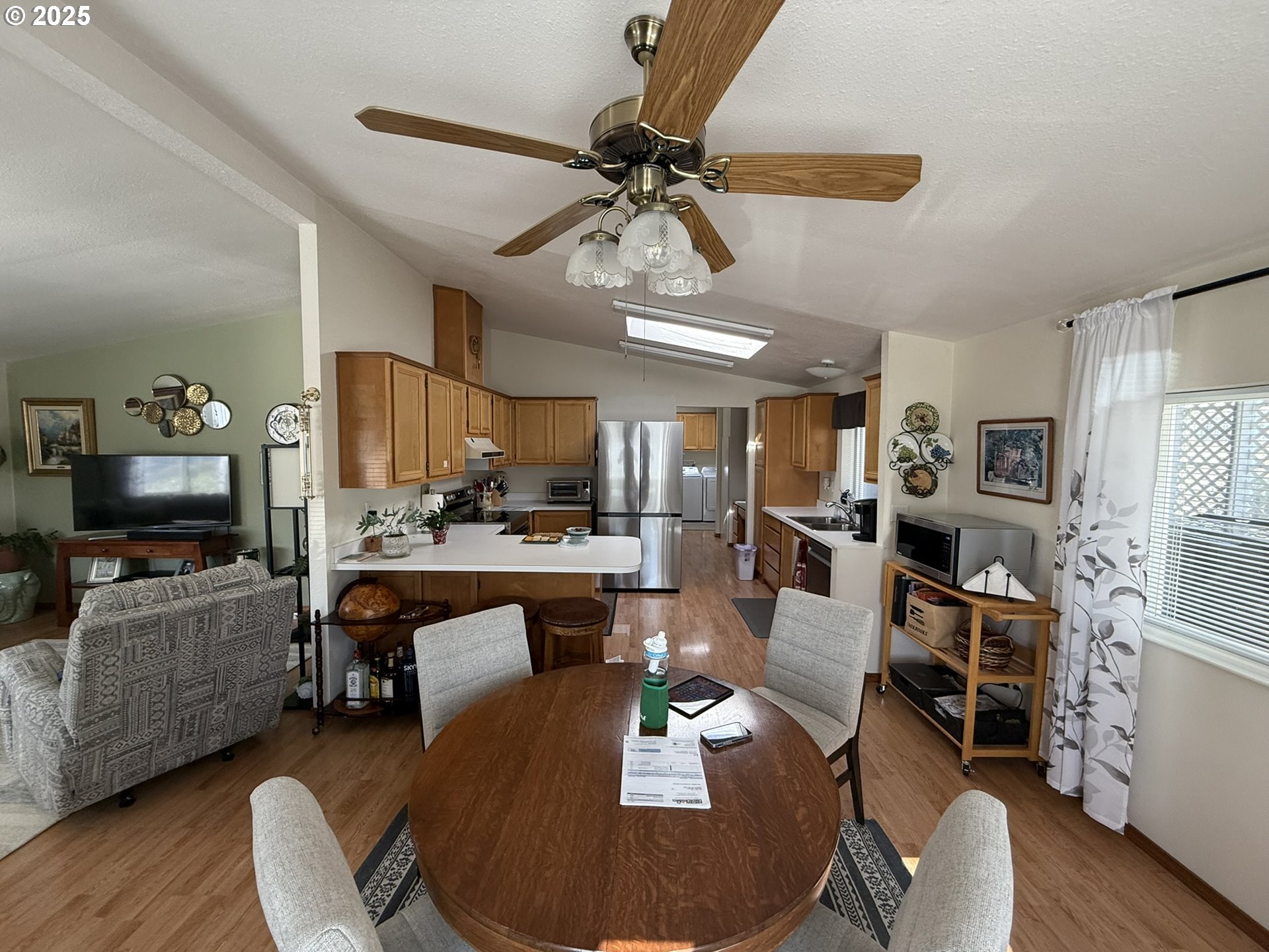 100 River Bend Road, Unit 17 Reedsport, OR 97467 - Photo 8 of 29 a living room with furniture a wooden floor and a ceiling fan