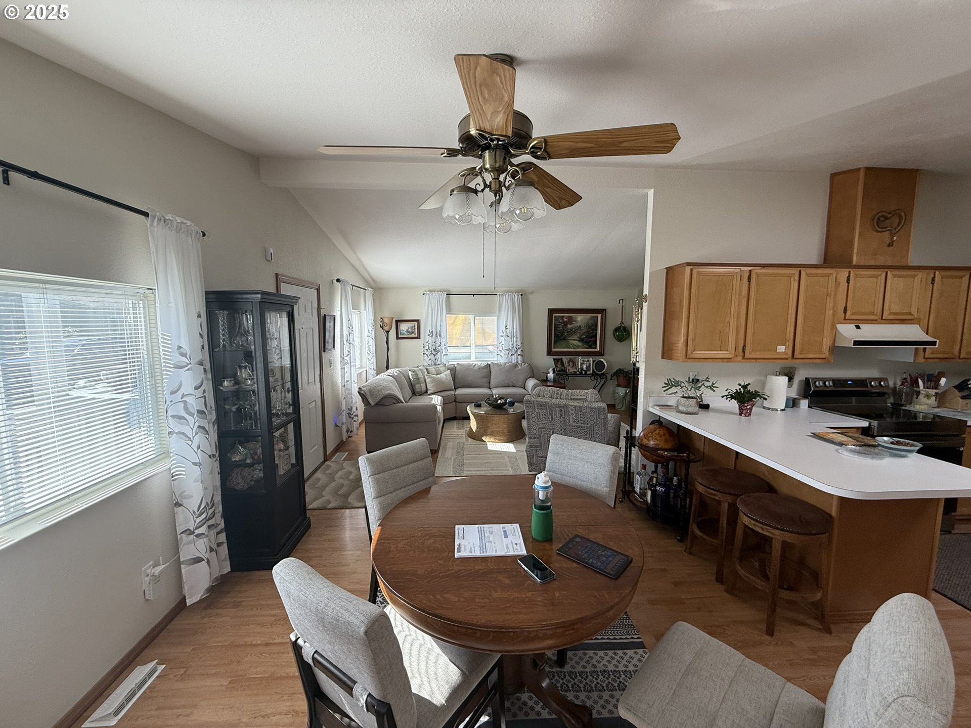 100 River Bend Road, Unit 17 Reedsport, OR 97467 - Photo 9 of 29 a room with stainless steel appliances kitchen island granite countertop a dining table chairs and a refrigerator