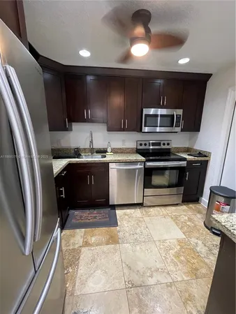 a kitchen with a refrigerator and a sink