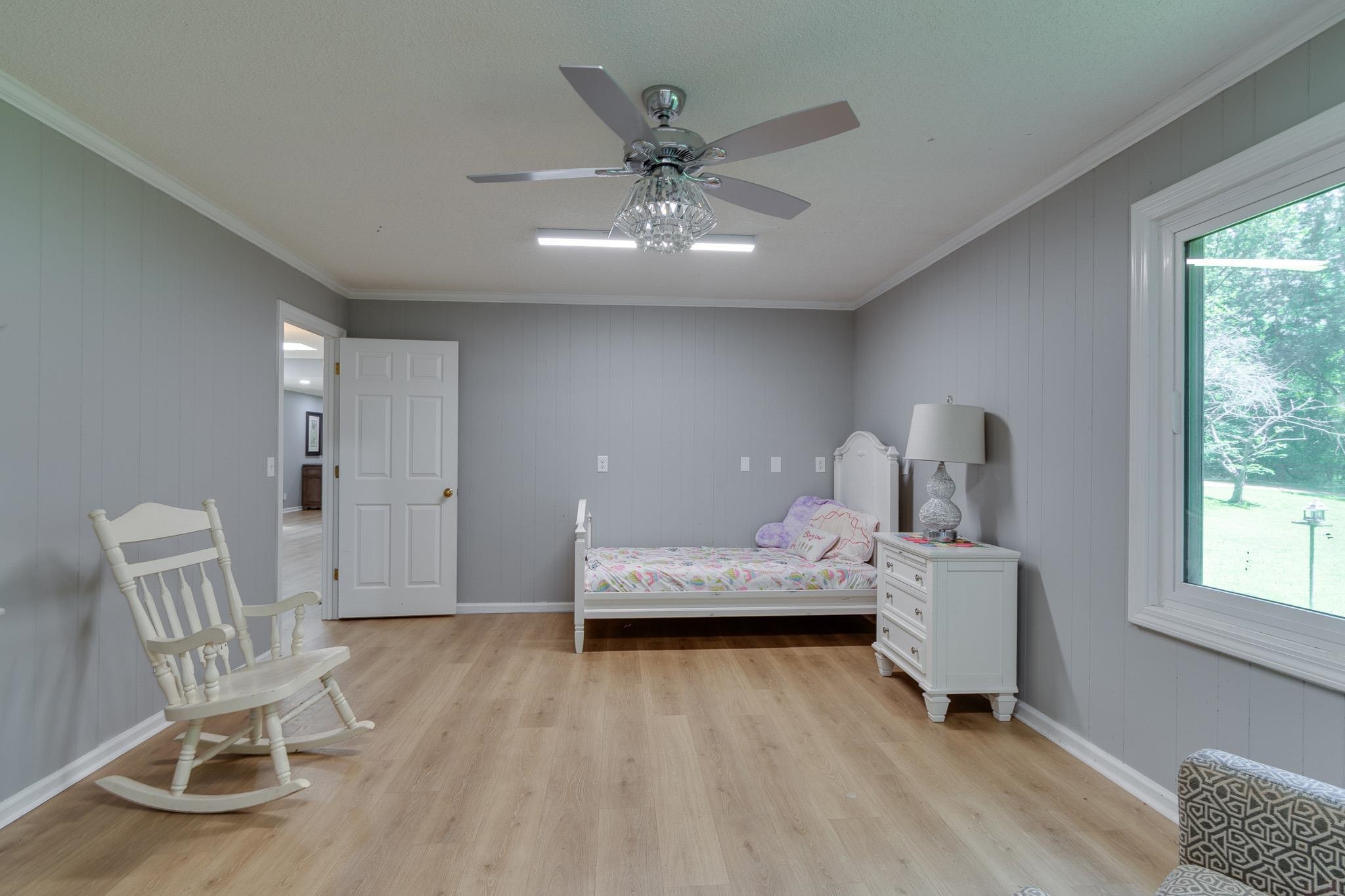 462 Woodbridge Road Somerville, TN 38068 - Photo 16 of 30 Bedroom with multiple windows, light wood-style flooring, crown molding, and a ceiling fan