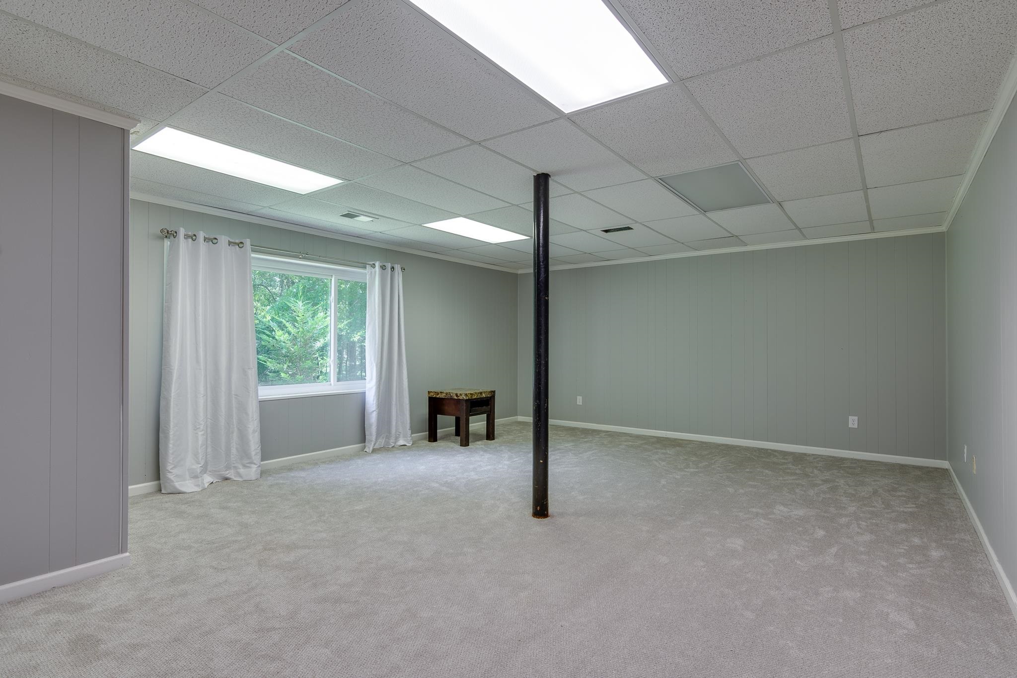 462 Woodbridge Road Somerville, TN 38068 - Photo 26 of 30 Basement with carpet floors and a drop ceiling