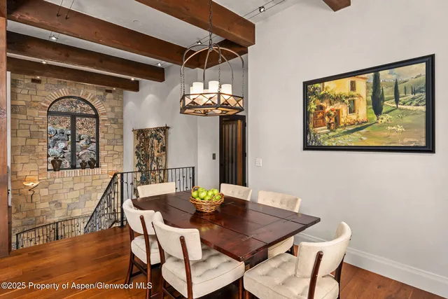 a view of a dining room with furniture and chandelier