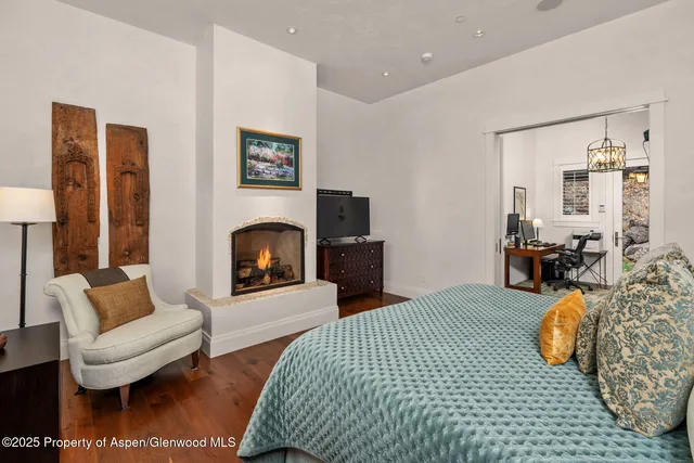 a bedroom with furniture and a fireplace